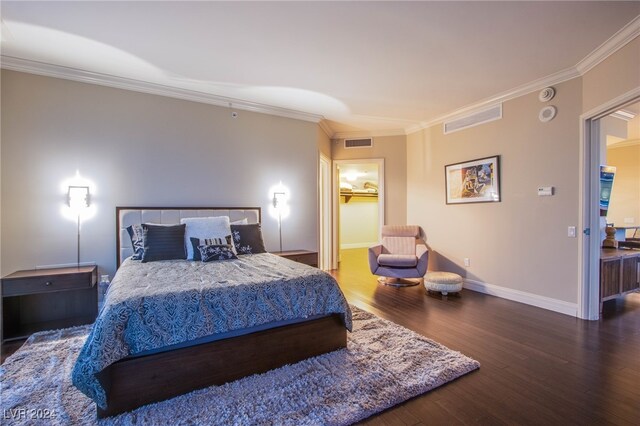 bedroom with ornamental molding and dark wood-type flooring