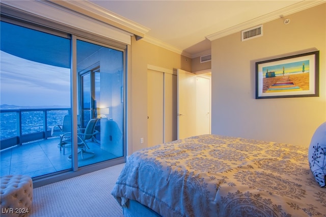 bedroom with access to exterior, carpet floors, a closet, and ornamental molding