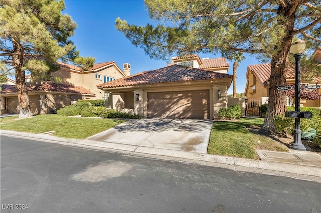 mediterranean / spanish-style home with a garage and a front yard