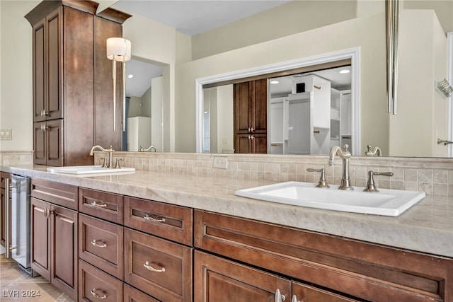 bathroom with tasteful backsplash and vanity