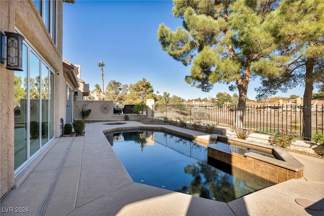 view of swimming pool with a jacuzzi and a patio