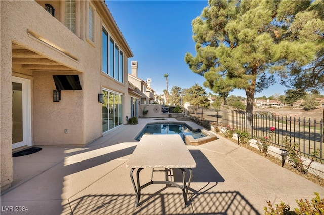 view of pool featuring an in ground hot tub and a patio area