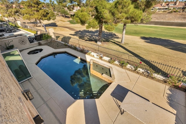 view of swimming pool featuring a patio area and a yard