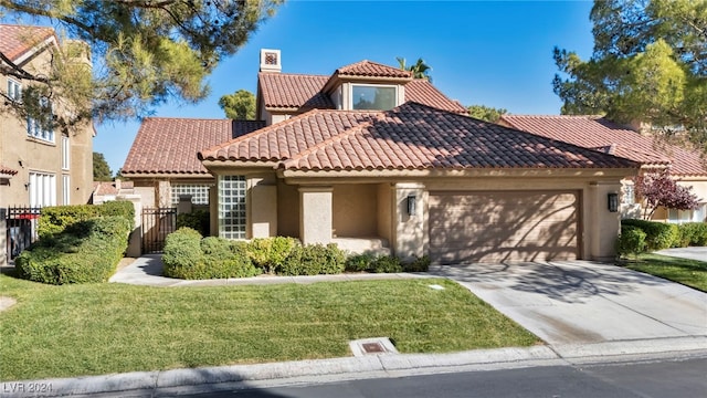 mediterranean / spanish-style home featuring a garage and a front lawn