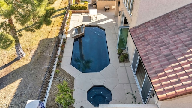 view of pool with an in ground hot tub and a patio