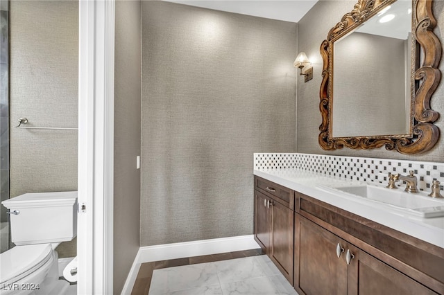 bathroom featuring decorative backsplash, vanity, and toilet