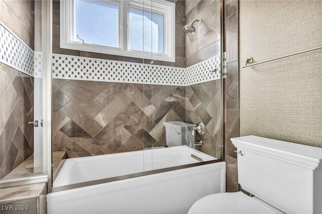 bathroom with bath / shower combo with glass door, tile walls, and toilet