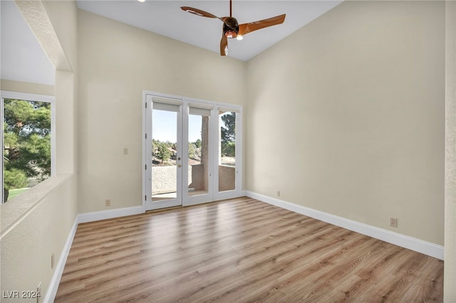 empty room with ceiling fan, french doors, and light hardwood / wood-style floors