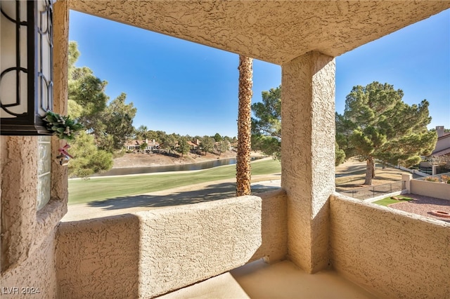 view of patio with a water view and a balcony