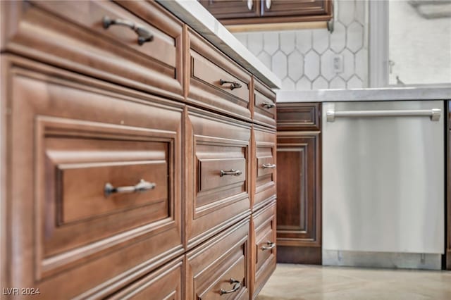 interior space featuring backsplash and stainless steel dishwasher