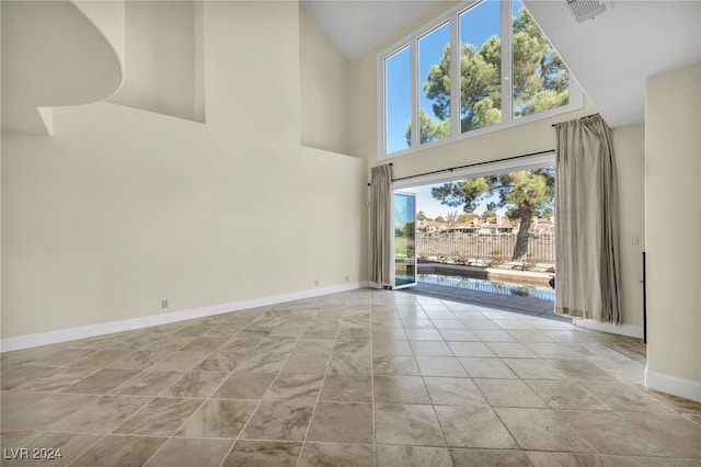 unfurnished room featuring high vaulted ceiling