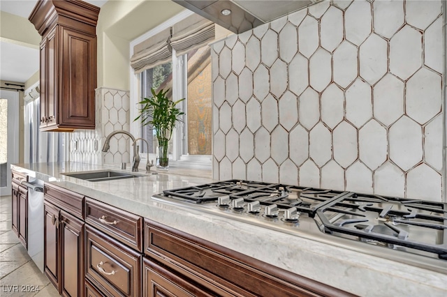 kitchen featuring sink, stainless steel appliances, and tasteful backsplash