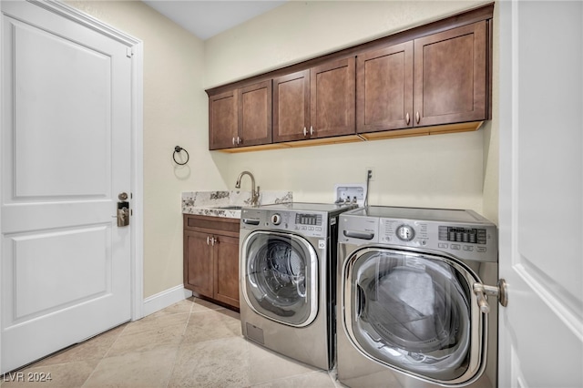 laundry area featuring washer and dryer, cabinets, light tile patterned floors, and sink