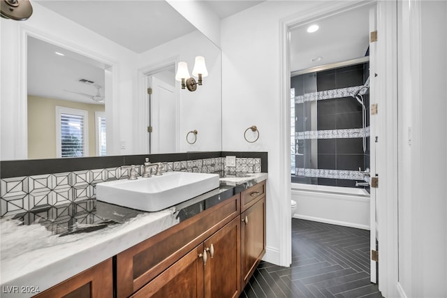 full bathroom featuring vanity, tiled shower / bath combo, toilet, parquet flooring, and tasteful backsplash