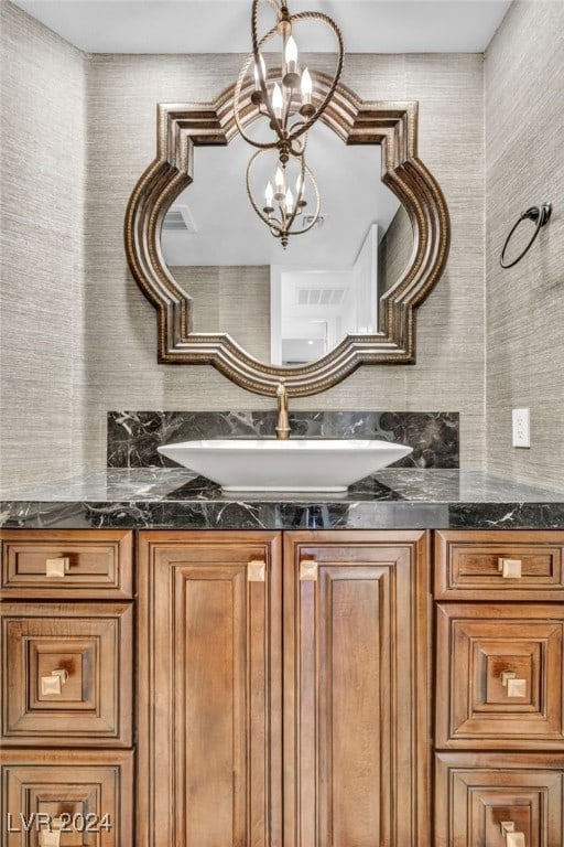 interior space featuring vanity and a notable chandelier