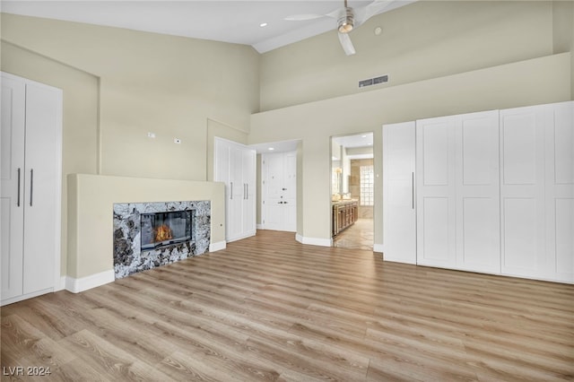 living room featuring ceiling fan, light hardwood / wood-style floors, and high vaulted ceiling