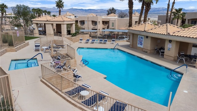 view of swimming pool featuring a mountain view and a patio