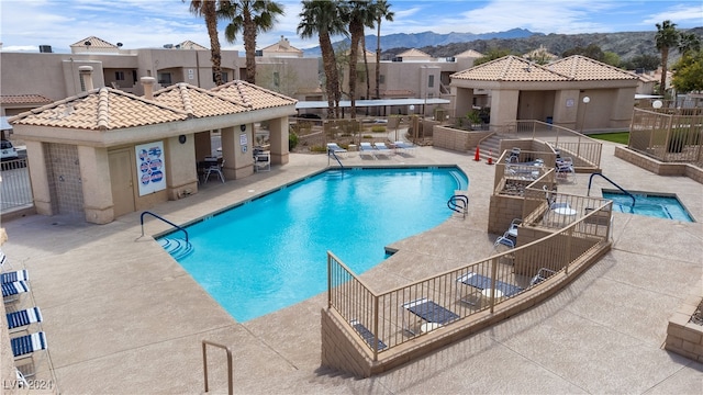 view of pool featuring a mountain view and a patio