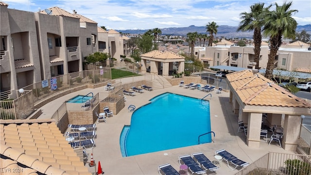 view of pool with a patio area and a mountain view