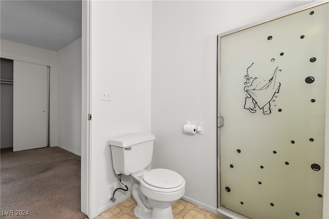 bathroom featuring a textured ceiling and toilet