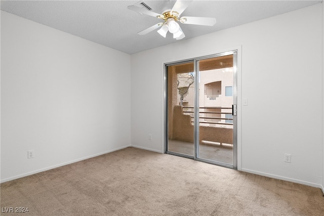 empty room featuring carpet flooring and ceiling fan