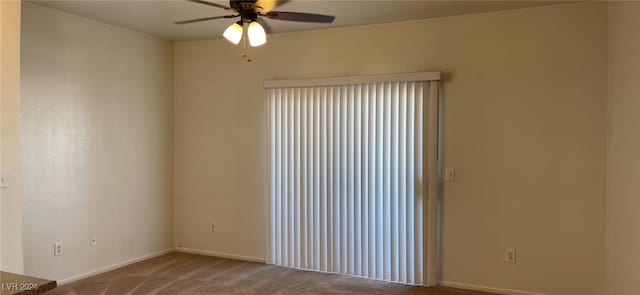 empty room with ceiling fan and carpet floors