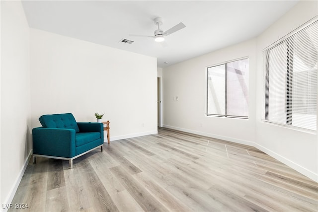 sitting room featuring light wood-type flooring and ceiling fan