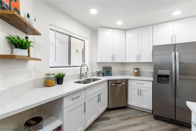 kitchen featuring light hardwood / wood-style floors, sink, white cabinetry, and stainless steel appliances