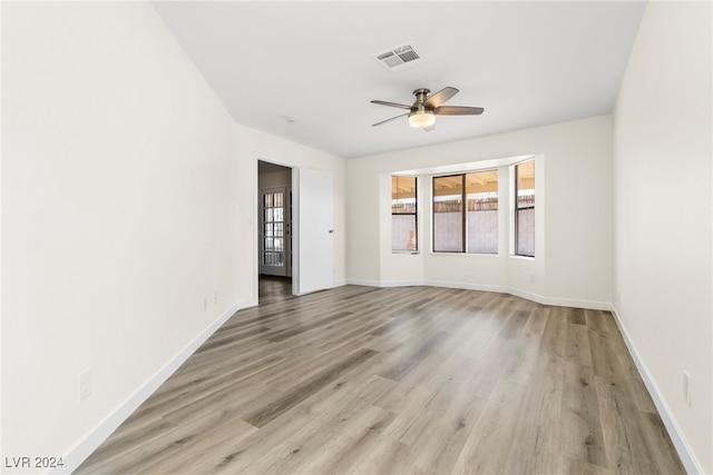 spare room featuring ceiling fan and light hardwood / wood-style flooring