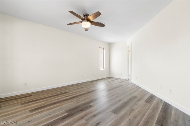 unfurnished room with ceiling fan and wood-type flooring