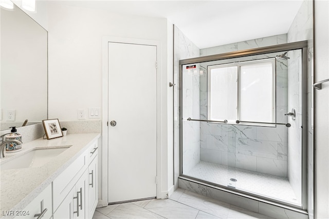 bathroom with vanity and a shower with shower door