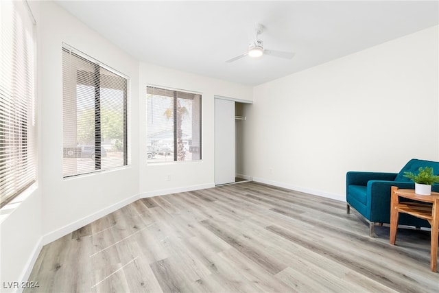 living area featuring ceiling fan and light wood-type flooring