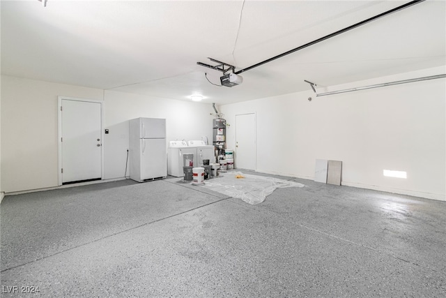 garage featuring secured water heater, white fridge, a garage door opener, and washer and clothes dryer