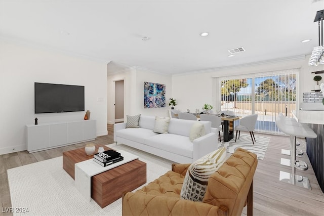 living room featuring light wood-type flooring and ornamental molding