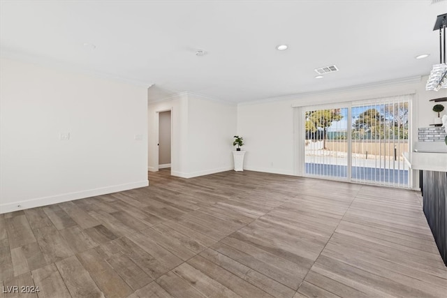 empty room featuring crown molding and light hardwood / wood-style floors