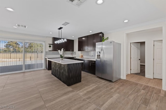 kitchen featuring a center island, stainless steel fridge with ice dispenser, pendant lighting, light hardwood / wood-style floors, and decorative backsplash