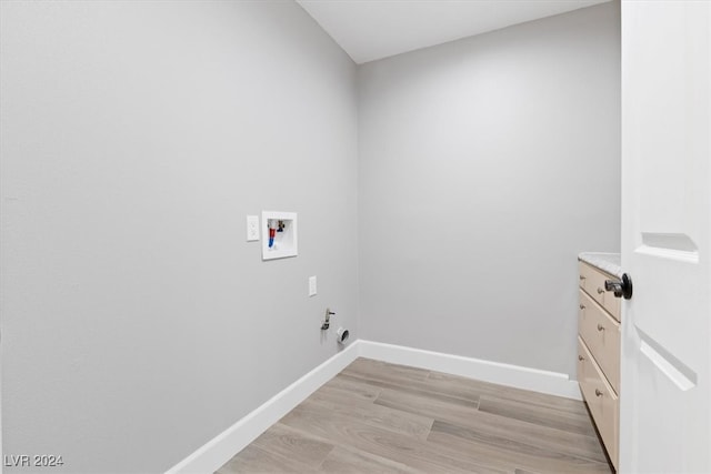 clothes washing area featuring hookup for a gas dryer, hookup for a washing machine, cabinets, and light wood-type flooring