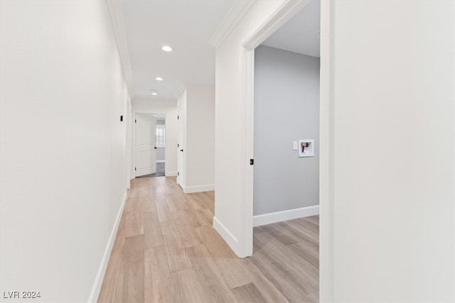 corridor with crown molding and light hardwood / wood-style floors