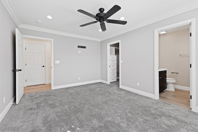 unfurnished bedroom featuring ensuite bathroom, crown molding, ceiling fan, and light colored carpet