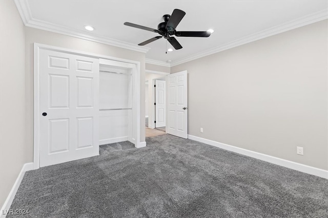 unfurnished bedroom with ceiling fan, a closet, dark carpet, and ornamental molding