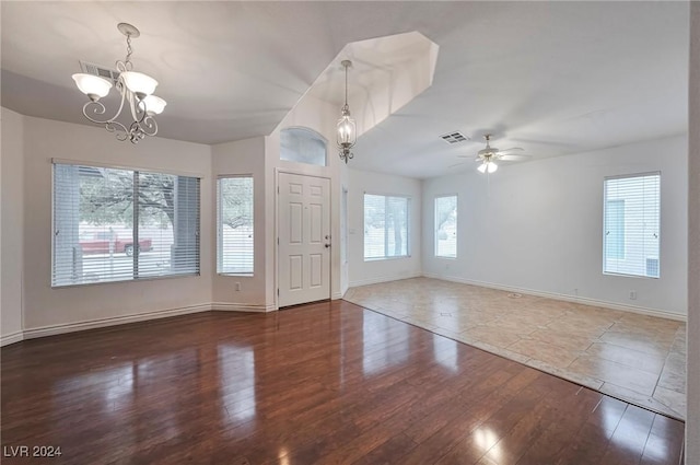 spare room featuring ceiling fan with notable chandelier and wood-type flooring