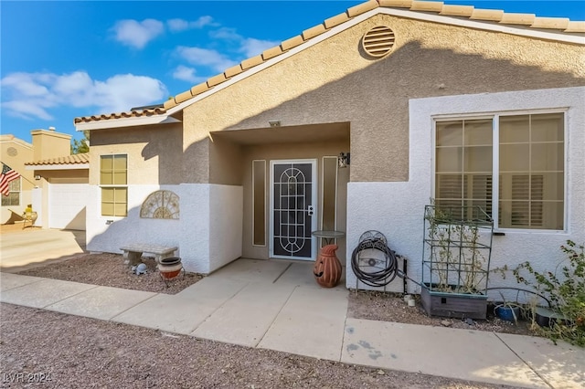 doorway to property with a patio area