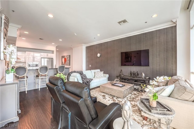 4525 Dean Martin Dr Unit 302, Las Vegas, NV 89103 - living room with an accent wall, ornamental molding, dark wood-style floors, and recessed lighting