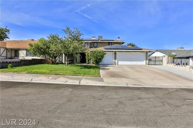 view of front of property with a front lawn and solar panels