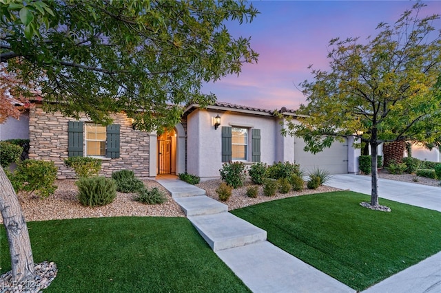 view of front of property featuring a yard and a garage