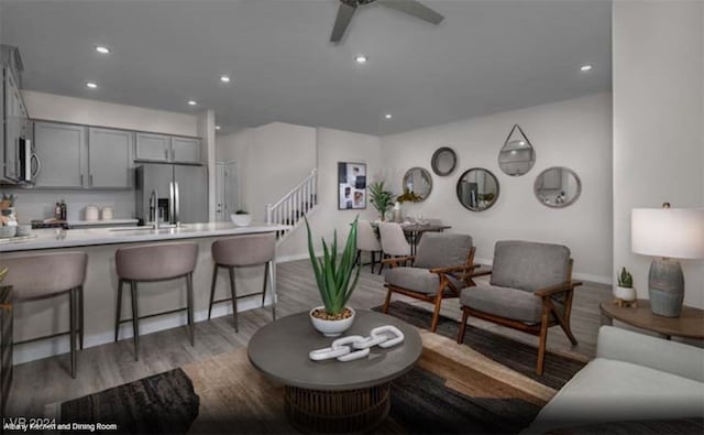 living room featuring sink, dark hardwood / wood-style floors, and ceiling fan