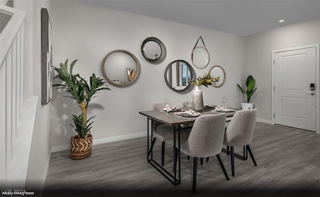 dining area with dark hardwood / wood-style flooring