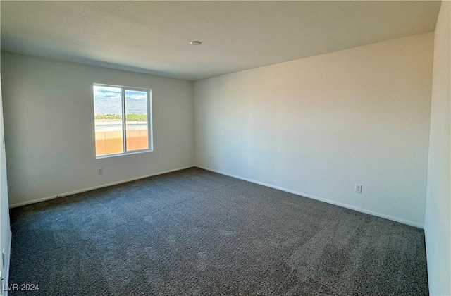 empty room with dark carpet