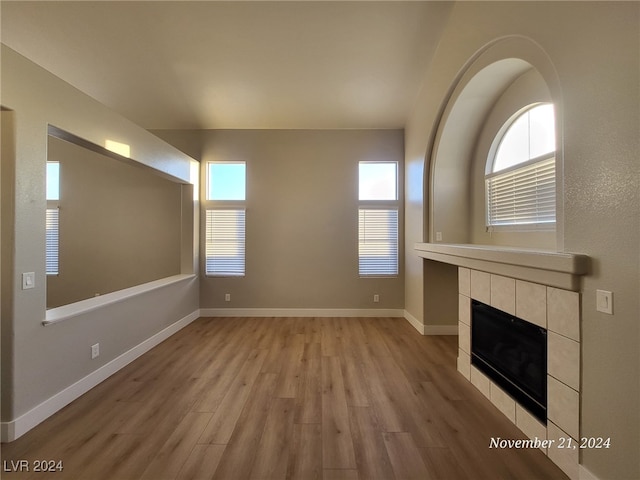 unfurnished living room featuring a fireplace and light hardwood / wood-style flooring