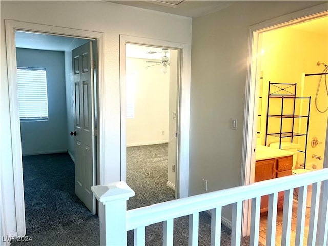 corridor with dark colored carpet